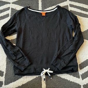 Black boatneck sweater with tie bottom details